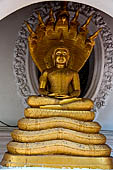 Thailand, Phra Pathom Chedi, the nation's largest pagoda in Nakorn Pathom. Buddha statue in niche of the outer courtyard.